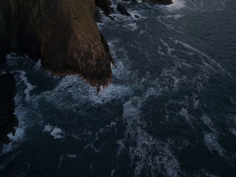 Flying over the sea and cliffs with waves breaking against the rocks Stock Footage 77509786