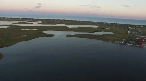 Flying over sea bay and fishing village Stock Footage