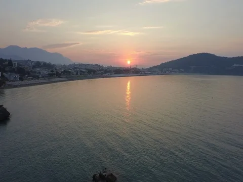 Flying over the sea from the sunset sun to the coast Stock Footage 72332175