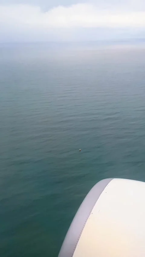 Flying over the sea, view from plane Stock Footage 310498458