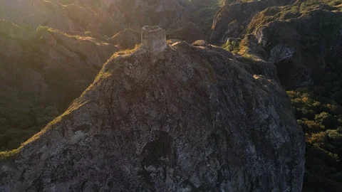 Flying over the sharp rocks with ancient little fortress in georgia Stock Footage 100180744