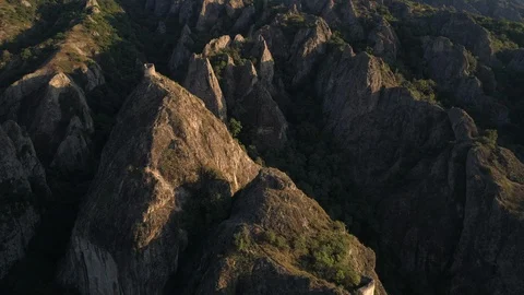 Flying over the sharp rocks with ancient little fortress in georgia Stock Footage 101000887