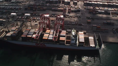 Flying over shipping containers and loading cranes at a dock in Port of Long Stock Footage 59107872