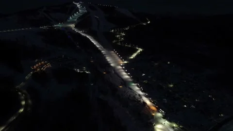 Flying over ski slope and rope-way with gondolas at ski resort at night. Stock-Footage 234806726