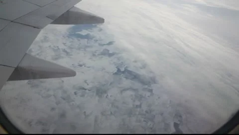 Flying over the sky with snow landscape in plane 2 Stock-Footage 7908113