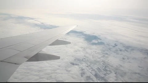 Flying over the sky with snow landscape in plane Stock Footage 7908178