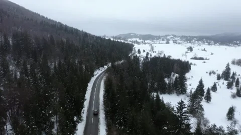 Flying Over slightly Snowy Forest in The Winter With Land Rover Car Driving. Stock-Footage 257199865