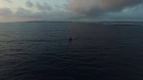 Flying over the small boat in the middle of St. Paul Bay of Malta. DJI-0339-02 Stock Footage 104503727