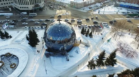Flying over the small city park in winter. spherical building. Car traffic Stock Footage 60747876