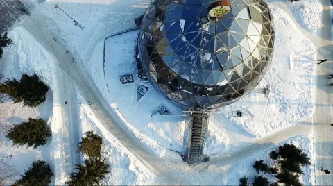 Flying over the small city park in winter. round building. spherical building Stock Footage 60748165