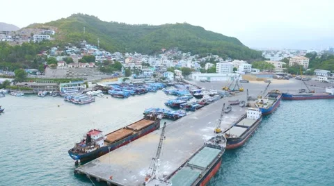 Flying over the small dock and moored boats in Nha Trang bay, Vietnam Video stock 62613970