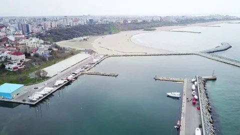 Flying over small harbor on the sea coast Stock-Footage 74115516