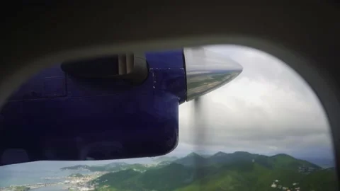Flying over small island in small plane Stock Footage 168772331