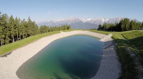 Flying over a small mountain lake - Aerial Flight Stock Footage 40739182