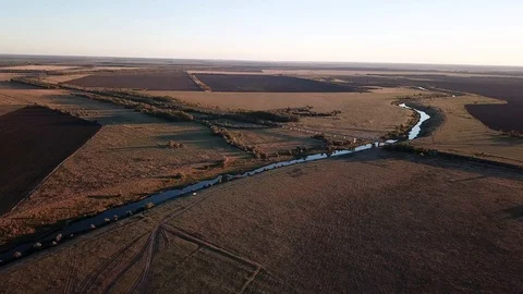 Flying over a small river, in the distance a railway bridge is visible Stock Footage 96211231