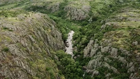 Flying over the small river in hilly area. Aerial video Video stock 208309416