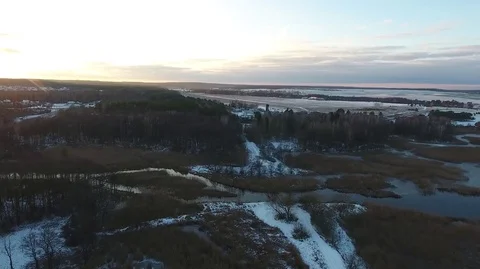 Flying over the small river on sunset in winter Stock Footage 71798865
