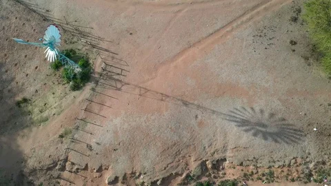 Flying over a small windmill in Kenya drone stock footage by DroneRune Stock Footage 126997947
