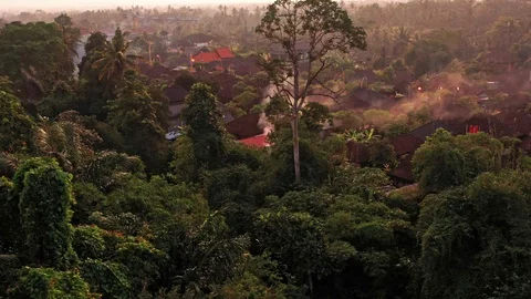 Flying over a smoking house after a fire in Bali Indonesia Stock Footage 102497690