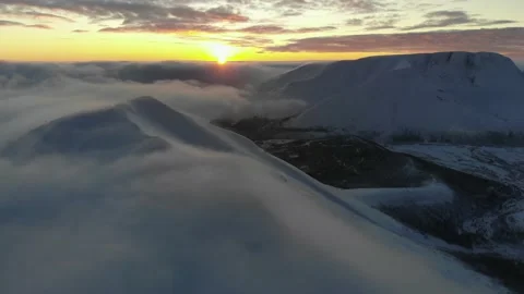 Flying over snow-capped mountains in the clouds at sunset. Aerial view. Colorful 스톡 동영상 147224845