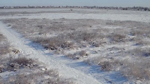 Flying over the snow-covered field aerial. Stock Footage 60416098