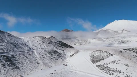 Flying over the snow-covered high mountains Stock Footage 293803073