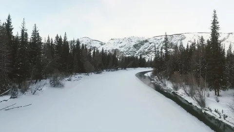 Flying over a snow-covered mountain river.  Siberia. Winter Stock Footage 109601877