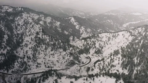 Flying over snow covered mountain in a snow storm. Drone aerial view outside Bou Video stock 124764672