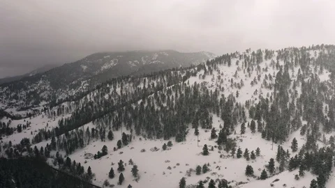 Flying over snow covered mountain in a snow storm. Drone aerial view outside Bou Video stock 124766568