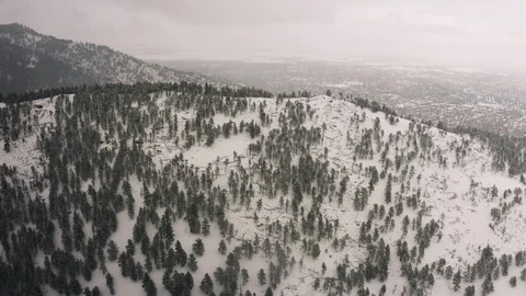 Flying over snow covered mountain in a snow storm. Drone aerial view outside Bou Video stock 124767433