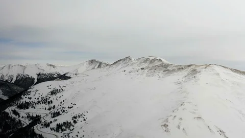 Flying over snow covered mountain after a snow storm. Drone aerial view outside  Video stock 124798728