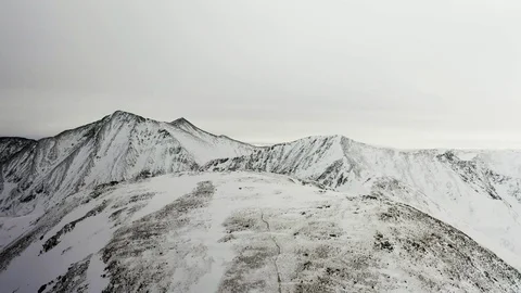 Flying over snow covered mountain after a snow storm. Drone aerial view outside  스톡 동영상 124807302