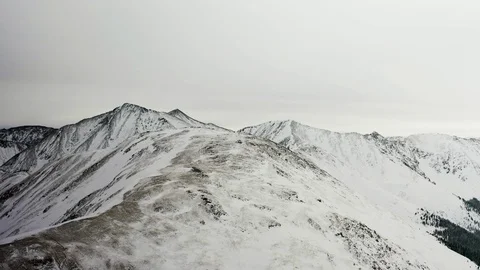 Flying over snow covered mountain after a snow storm. Drone aerial view outside  Video stock 124807361