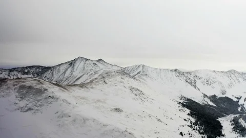 Flying over snow covered mountain after a snow storm. Drone aerial view outside  Video stock 124808022