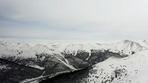 Flying over snow covered mountain after a snow storm. Drone aerial view outside  Vídeo Stock 124808744