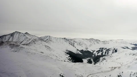 Flying over snow covered mountain after a snow storm. Drone aerial view outside  Video stock 124808943