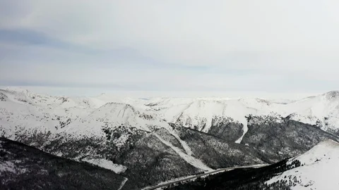 Flying over snow covered mountain after a snow storm. Drone aerial view outside  Video stock 124809014