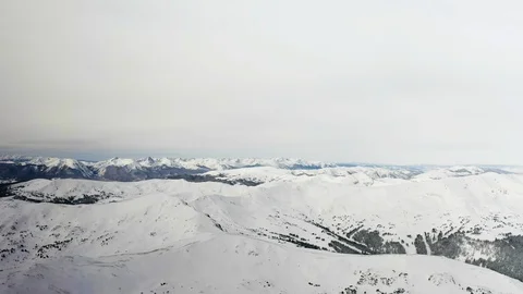 Flying over snow covered mountain after a snow storm. Drone aerial view outside  Video stock 124997613