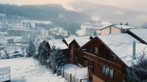 Flying over snow-covered roofs at a ski resort, aerial shot 스톡 동영상 128150237