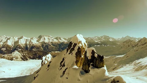Flying over snow mountain peak landscape overlooking panorama Stock Footage 72869959