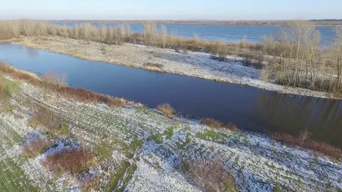 Flying over the snow to plow the field and small river 스톡 동영상 69980754