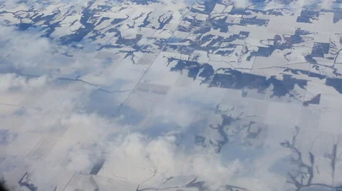 Flying over snowcaps on mountains with clouds Stockbeeldmateriaal 43914072