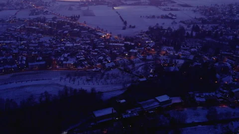 Flying over a snowy city at late sunset, Uster, Switzerland Stock Footage 323272178
