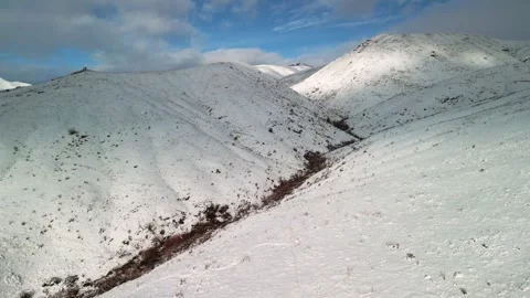 Flying Over Snowy Hillside - 2 Stock Footage 297163667
