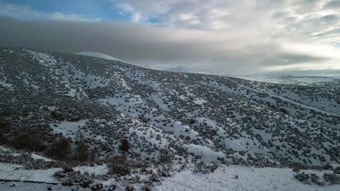Flying Over Snowy Hillside - 3 Stock Footage 297163706