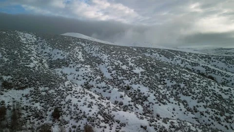 Flying Over Snowy Hillside - 5 Stock Footage 297163691