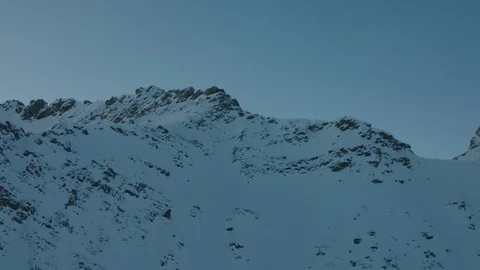 Flying over snowy mountain ridges just before sunrise Stock Footage 101913499