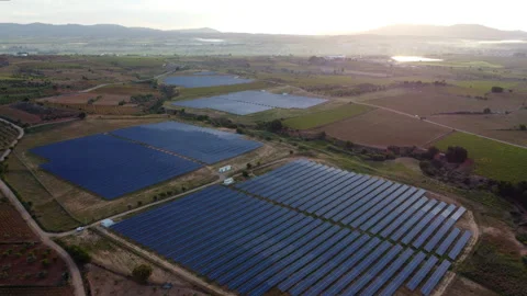 Flying over solar panels at a solar plant in Spain during sunrise Stock Footage 258284600