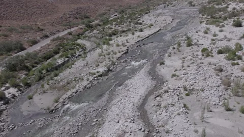 Flying over stream running through desert landscape (shot in log @60fps) Stock Footage 245526870