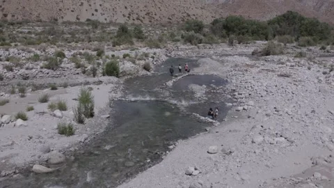 Flying over stream running through desert landscape (shot in log @60fps) Stock Footage 245579284